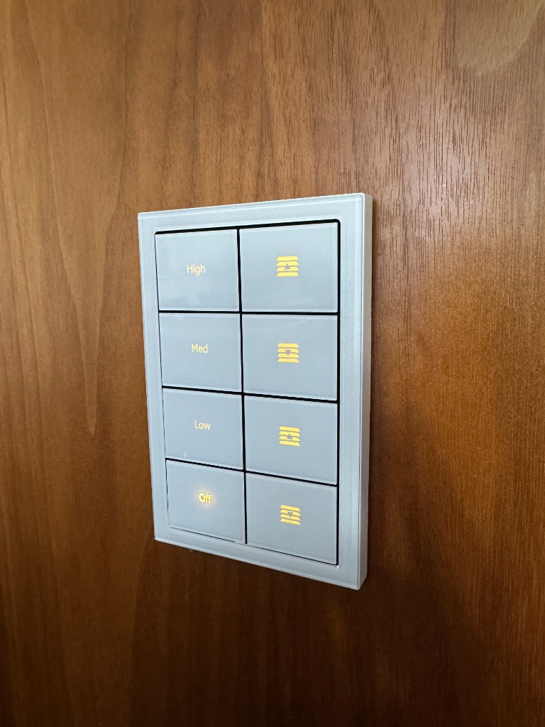 Architectural glass smart lighting keypad and blind controller on timber wall